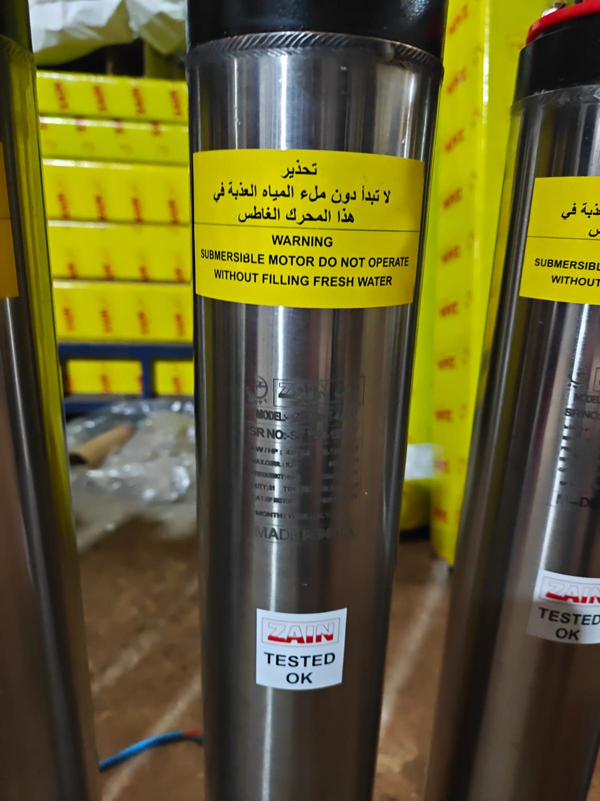 Zain submersible motor showing the engraved nameplate and red Tested OK sticker